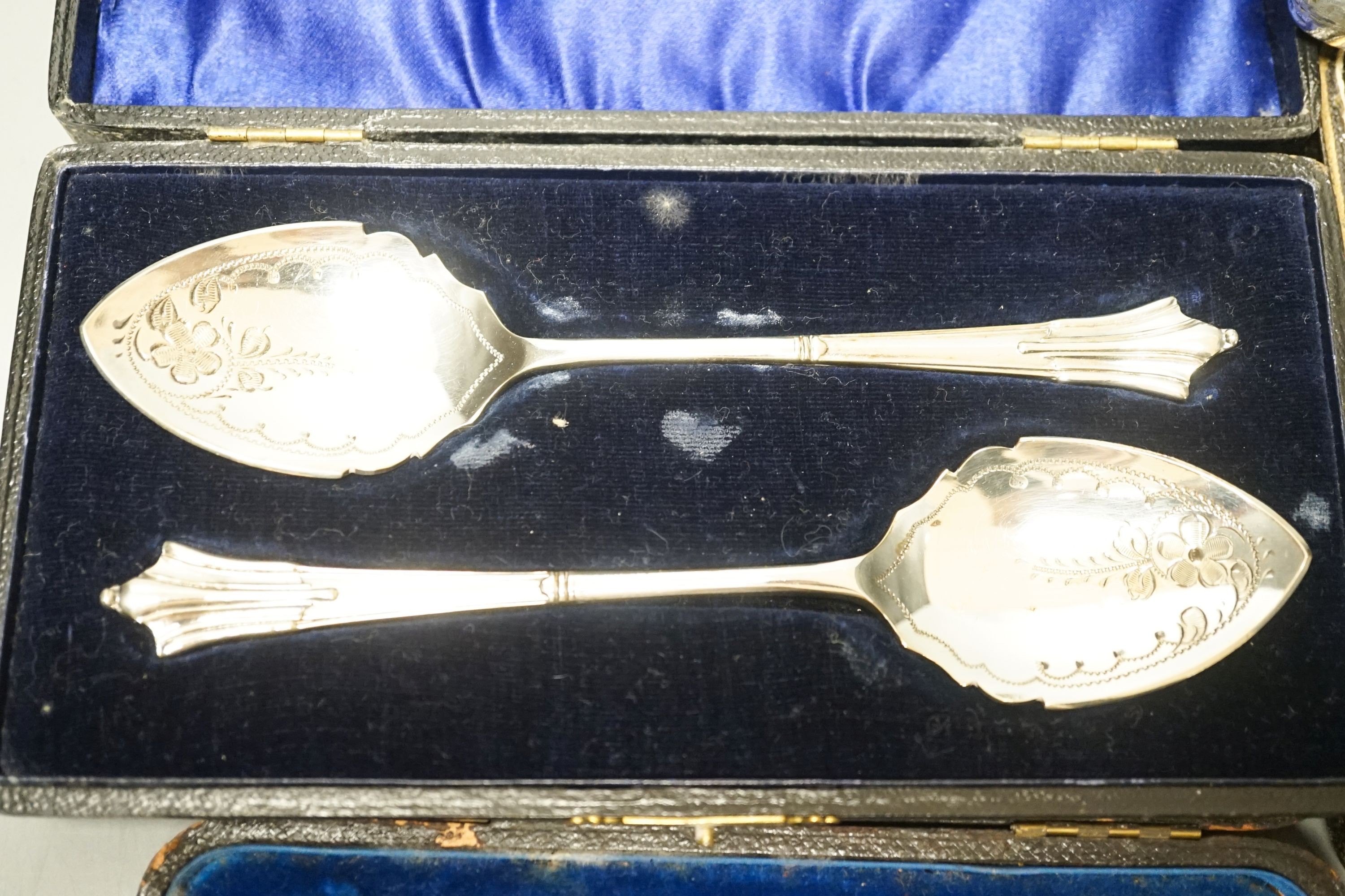 Four cased sets of cutlery including silver teaspoons and pair of silver preserve spoons and a silver cigarette case.